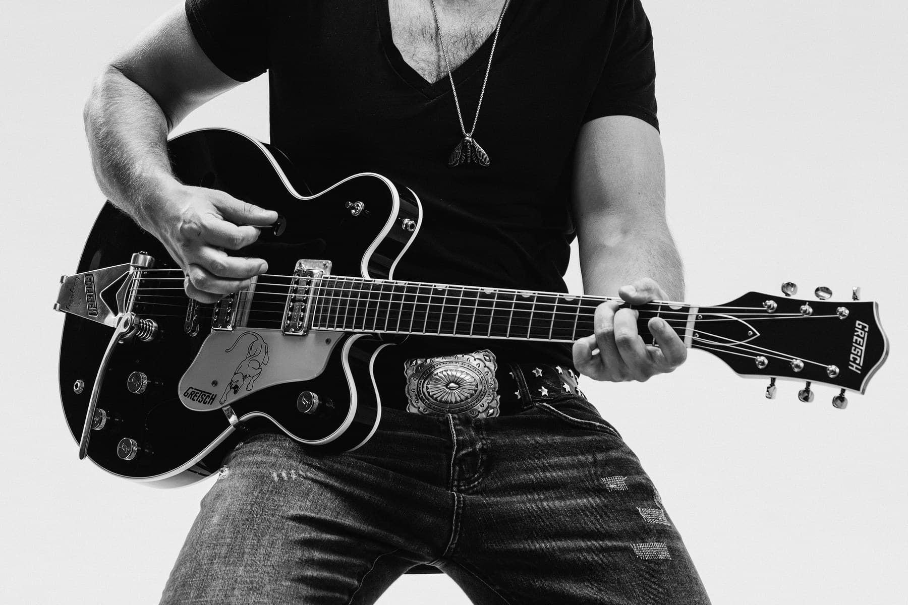 Close-up of GRAUX's hands on a Gretsch guitar