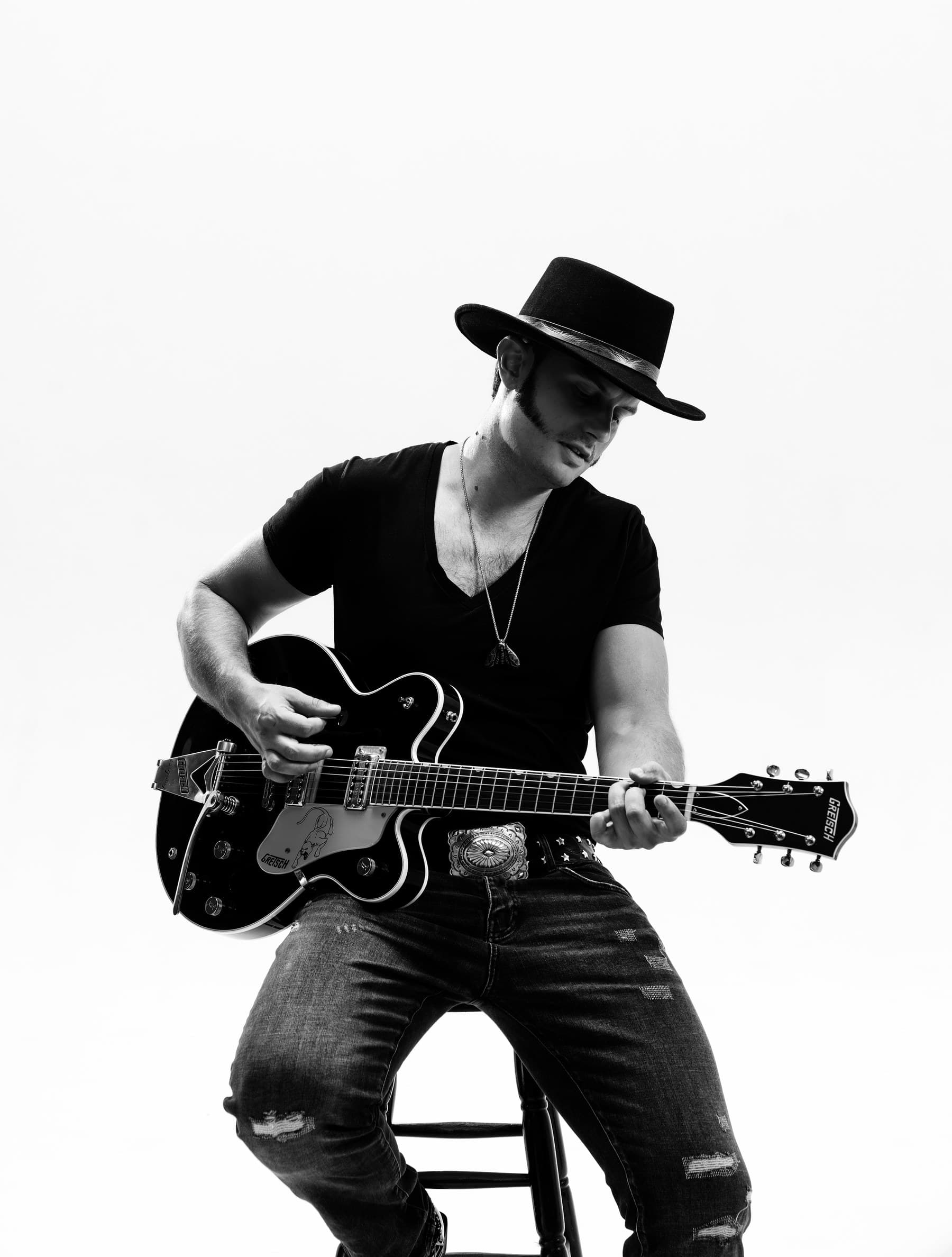 GRAUX seated with a Gretsch guitar, studio portrait